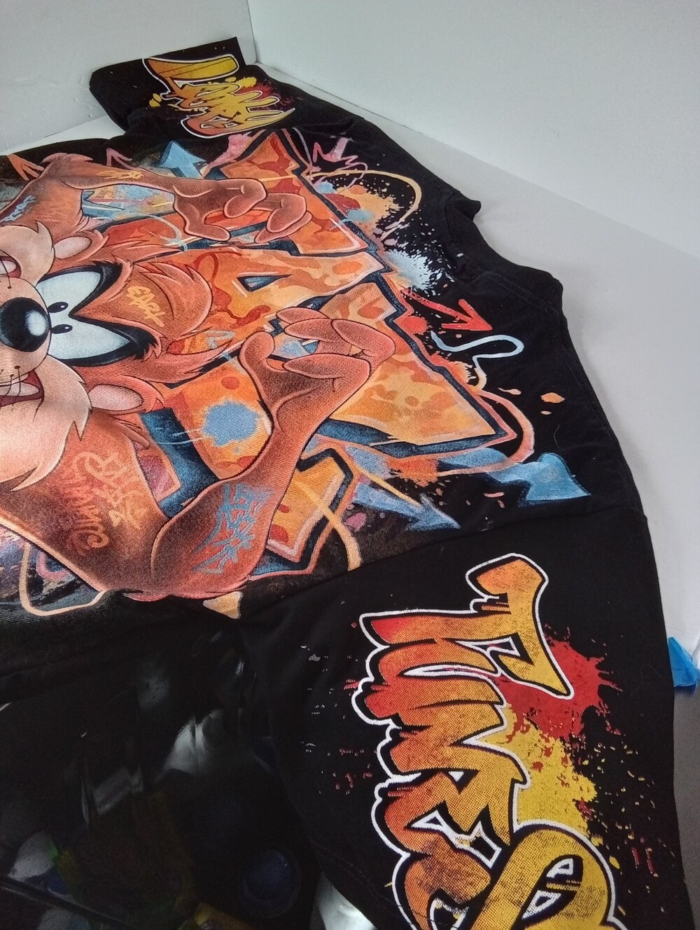 Apple Black Taz AOP Graphic Tee with Gold Logo and Multicolor Front Print - Picture 8 of 10